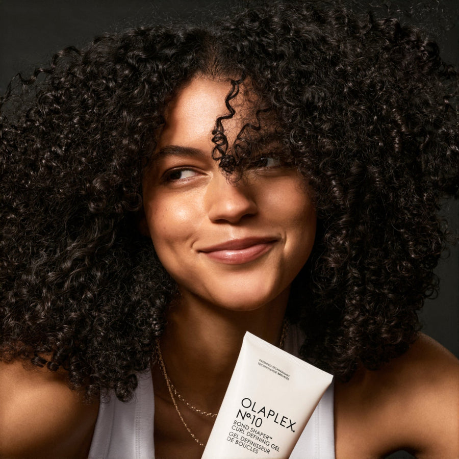Close-up of smiling woman with tight, coiled curls