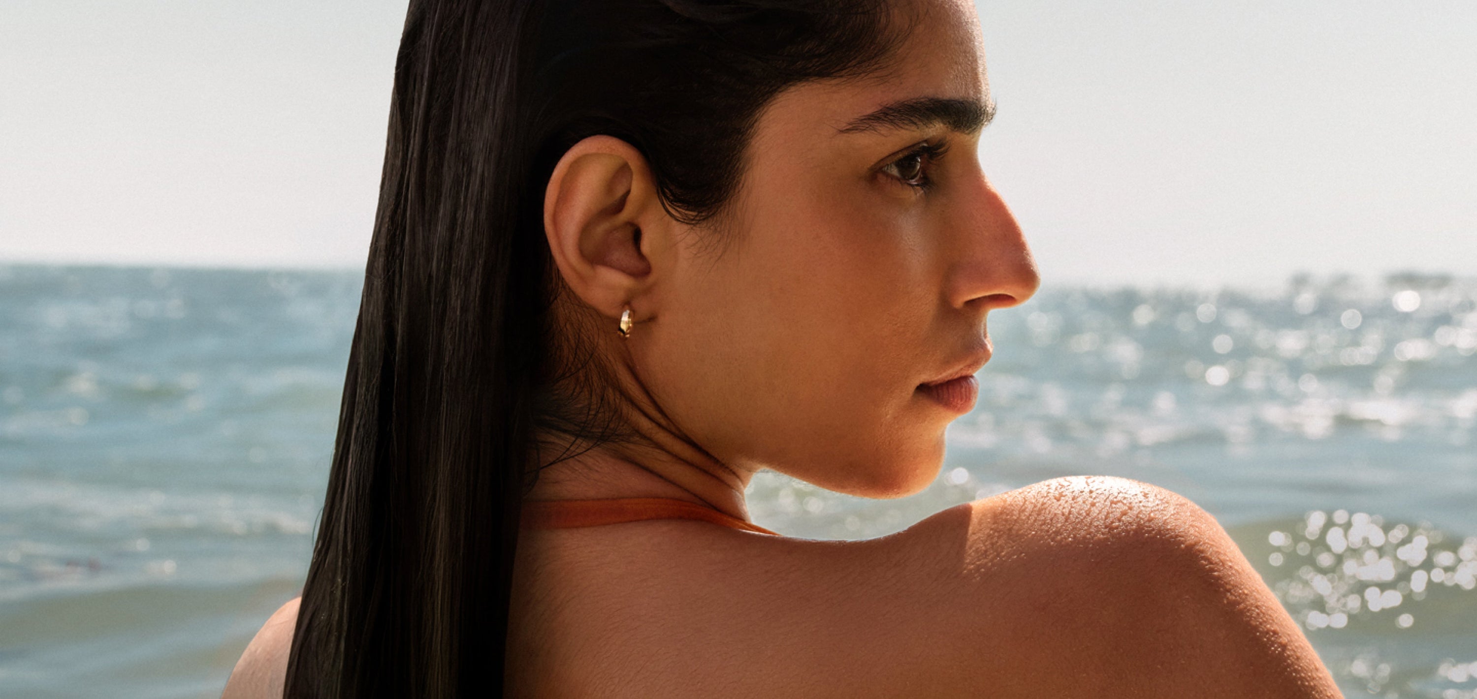 A woman with sleek hair in the ocean