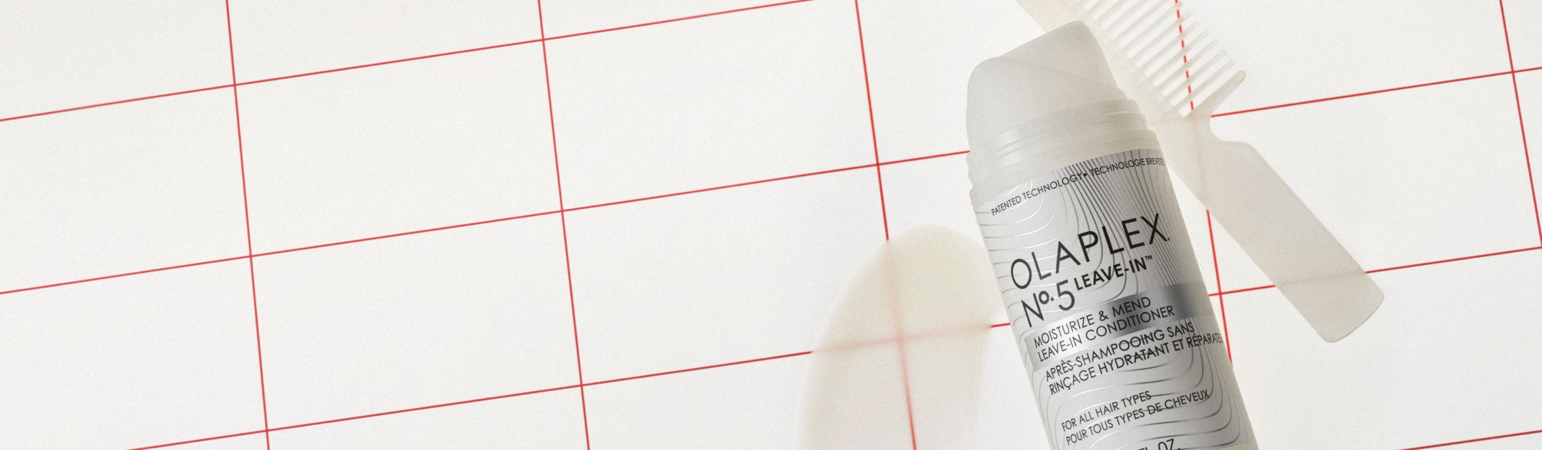 Image features a bottle of OLAPLEX leave-in conditioner on a white background with red gridlines and a product smear