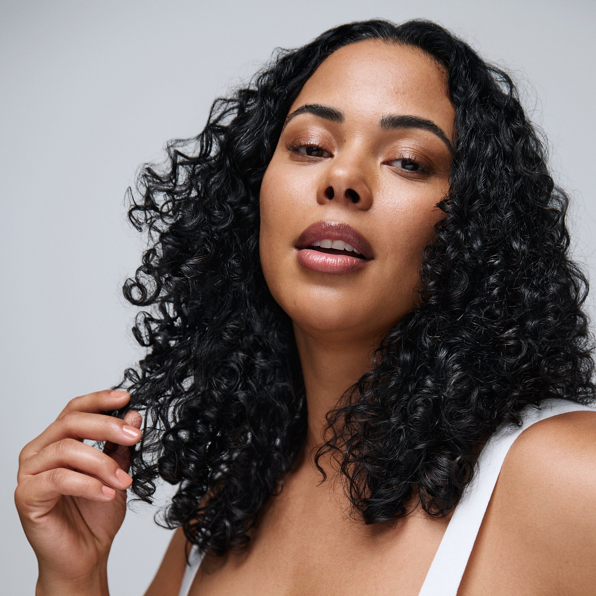 A woman with long, curly, dark hair