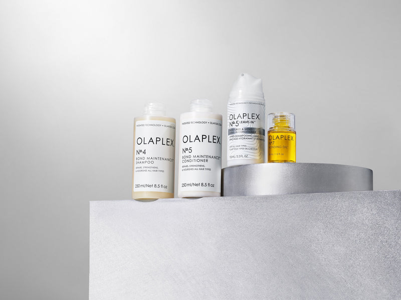 OLAPLEX products grouped together on a pedestal 