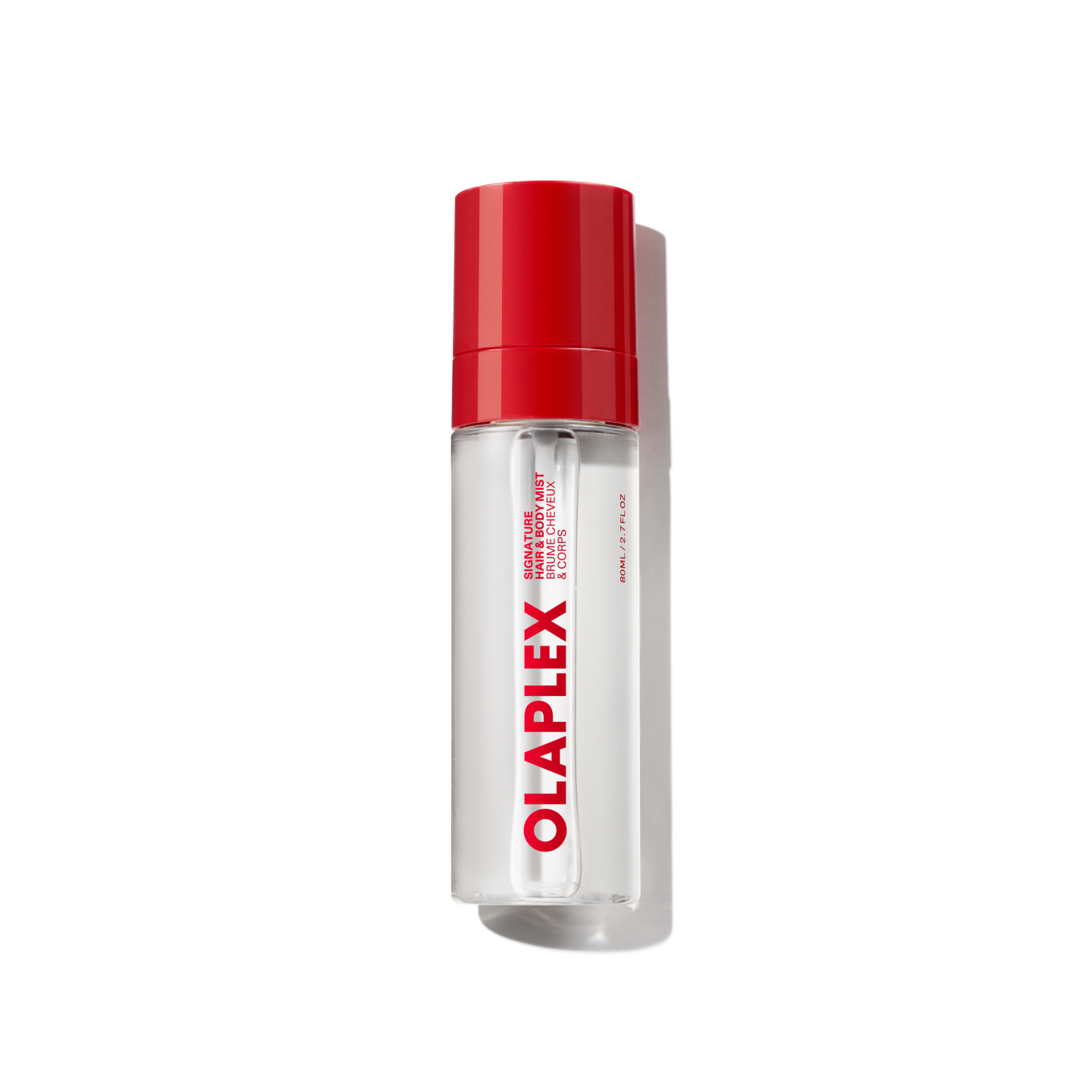 Un flacon transparent de brume parfumée pour les cheveux et le corps OLAPLEX avec un bouchon rouge vif et un logo OLAPLEX voyant imprimé verticalement sur le devant, présenté sur un fond de grille transparente.