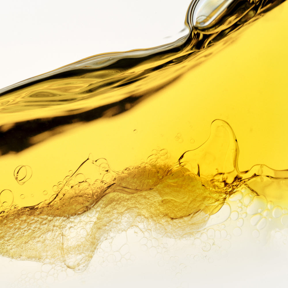 hover

A vibrant close-up macro abstract of a golden-yellow oil or serum liquid, creating dynamic waves and swirling textures against a crisp white background. Tiny, delicate bubbles are scattered throughout the translucent fluid, capturing the light. - alternate view